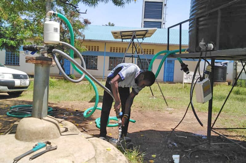 Installing a water pump at a school near Kisumu Kenya