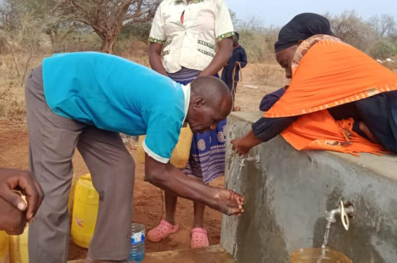 Man washes hands with water from a tap